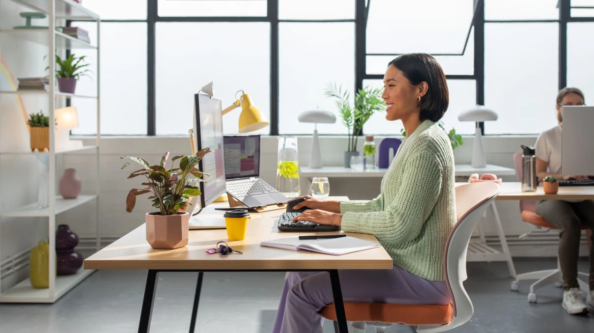 A background photo of a home office with multiple users on their own work stations