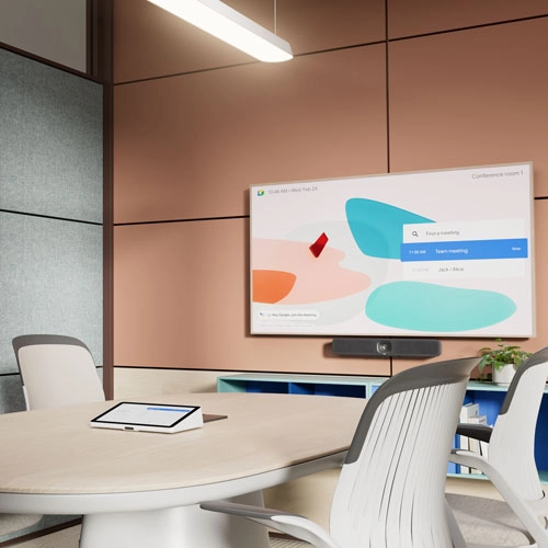 An image of a modern office space for four with a room controller and large display device